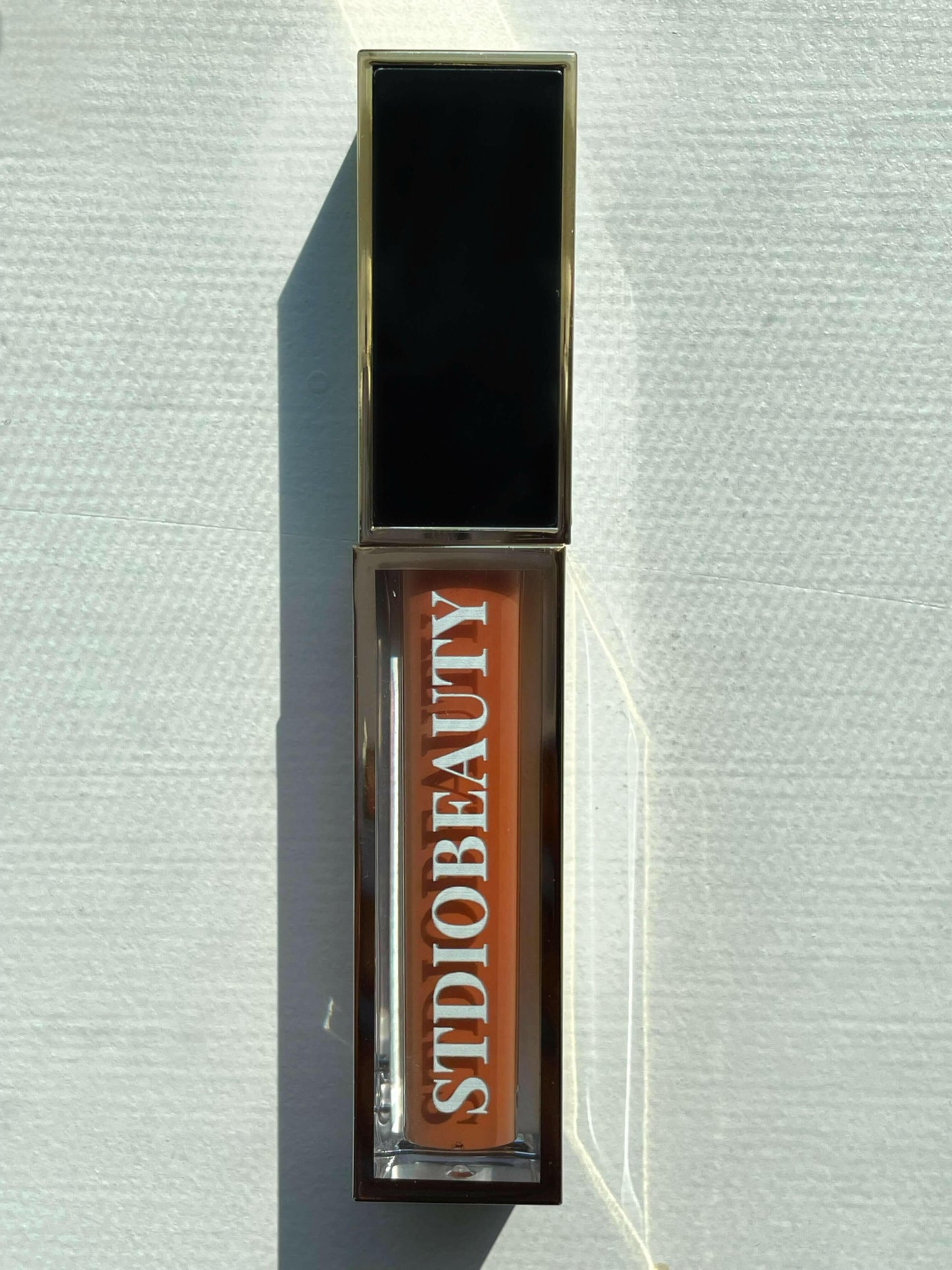 INTERLUDE | LIQUID GOLD LIP GLOSS.